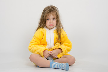 Image showing Offended girl in yellow bathrobe
