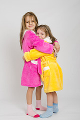 Image showing Two sisters hug after a bath