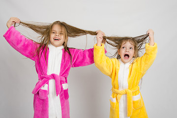 Image showing Two girls having fun in dressing gowns keep wet hair