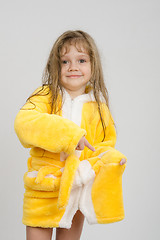 Image showing Girl pointing to a hole in the pocket of his robe