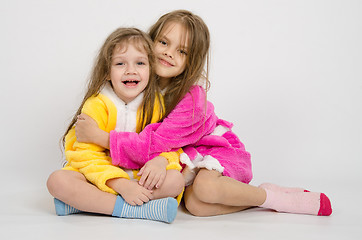 Image showing Two girls sit in robes