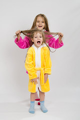 Image showing Girl holding her sisters wet hair