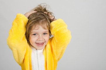 Image showing Joyful girl in a yellow bathrobe