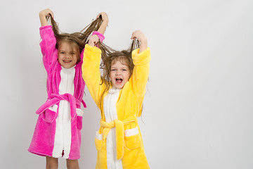 Image showing Two girls in the bath robes raised their wet hair