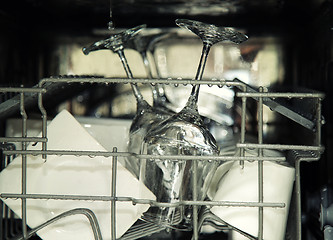 Image showing details of open dishwasher, utensils with drops in during washin