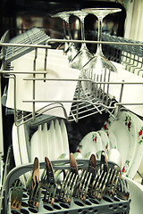 Image showing details of Open dishwasher with clean utensils