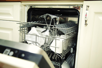Image showing details of Open dishwasher with clean utensils