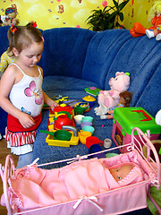 Image showing little girl playing with toys in her room