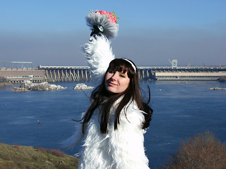 Image showing The young bride in a white dress with a bouquet of flowers