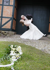 Image showing Bridal bouquet before wedding couple kissing