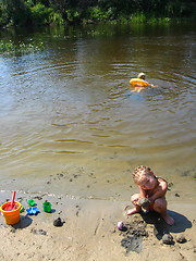 Image showing little girls playing on the sand at the river