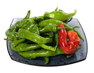 Image showing Green and red chili peppers on glass plate