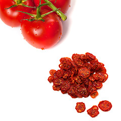 Image showing Ripe tomato with water drops and dried slices of tomato