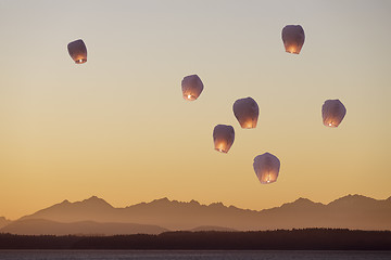 Image showing Sky lanterns flying upwards\r