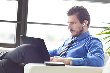 Image showing Businessman in office working on his laptop. 