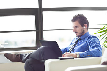 Image showing Businessman in office working on his laptop. 