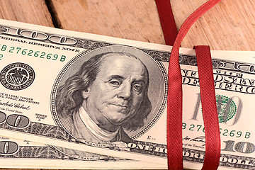 Image showing Bundle of dollars tied with ribbon