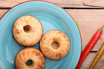 Image showing cheese cake on blue plate with red pepper