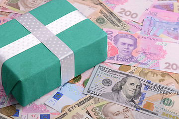 Image showing american and european money background and green gift box