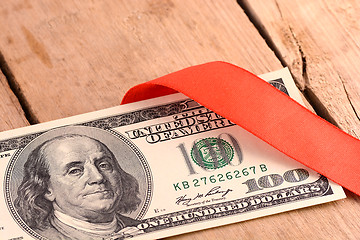 Image showing One Hundred Dollar Bills Wrapper in Red Ribbon