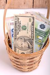 Image showing money set in a basket, dollars, euro and ukrainian money