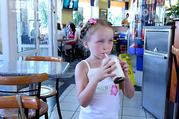 Image showing beautiful girl having dinner in cafe