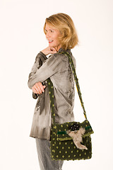 Image showing Senior smiling lady with a designer handbag