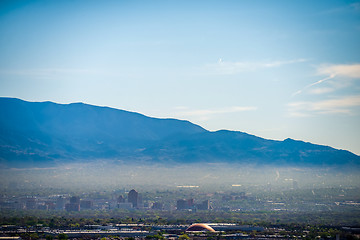 Image showing  Albuquerque new mexico skyline in smog  with mountains