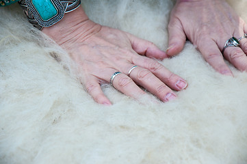 Image showing Female Muslim hands works with wool