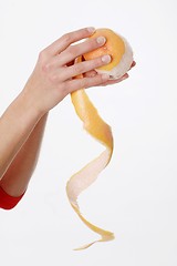 Image showing Hands peeling orange