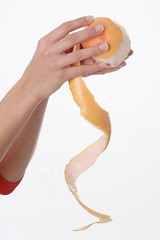 Image showing Hands peeling orange