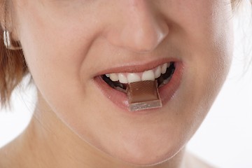 Image showing Woman eating chocolate