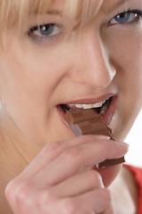 Image showing Woman eating chocolate