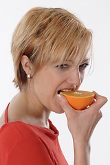 Image showing Woman eating orange