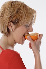 Image showing Woman eating orange