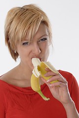 Image showing Woman eating banana