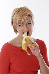 Image showing Woman eating banana