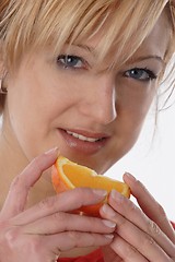 Image showing Woman eating orange