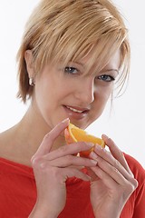 Image showing Woman eating orange