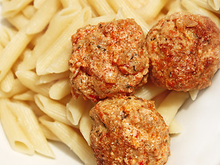 Image showing Three meatballs with sauce over pasta