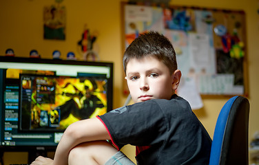 Image showing Boy using computer at home, playing game