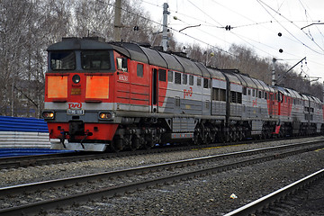 Image showing The engine of gray color moves on railway tracks.