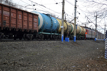 Image showing The cargo train with tanks moves on railway tracks.