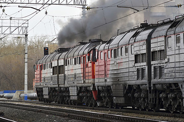 Image showing The smoking engine moves in the ways.