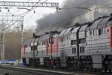 Image showing The smoking engine moves in the ways.