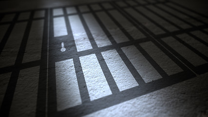 Image showing Jail cells bars casting shadows on floor.