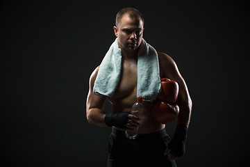 Image showing boxer resting with water and a towel after training