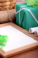 Image showing green gift box and wooden board, holiday concept