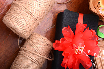 Image showing gift box, flowers and old thread