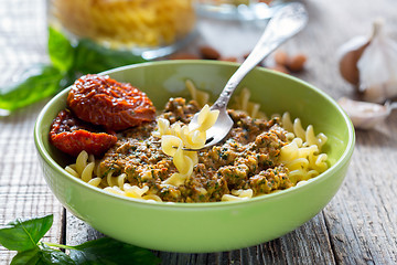 Image showing Pasta with pesto with dried tomatoes, garlic and chili.